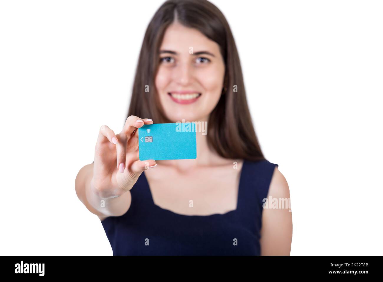 Happy young woman holding to camera a credit card. Close up portrait of a girl advertising a bank isolated on white background with copy space Stock Photo