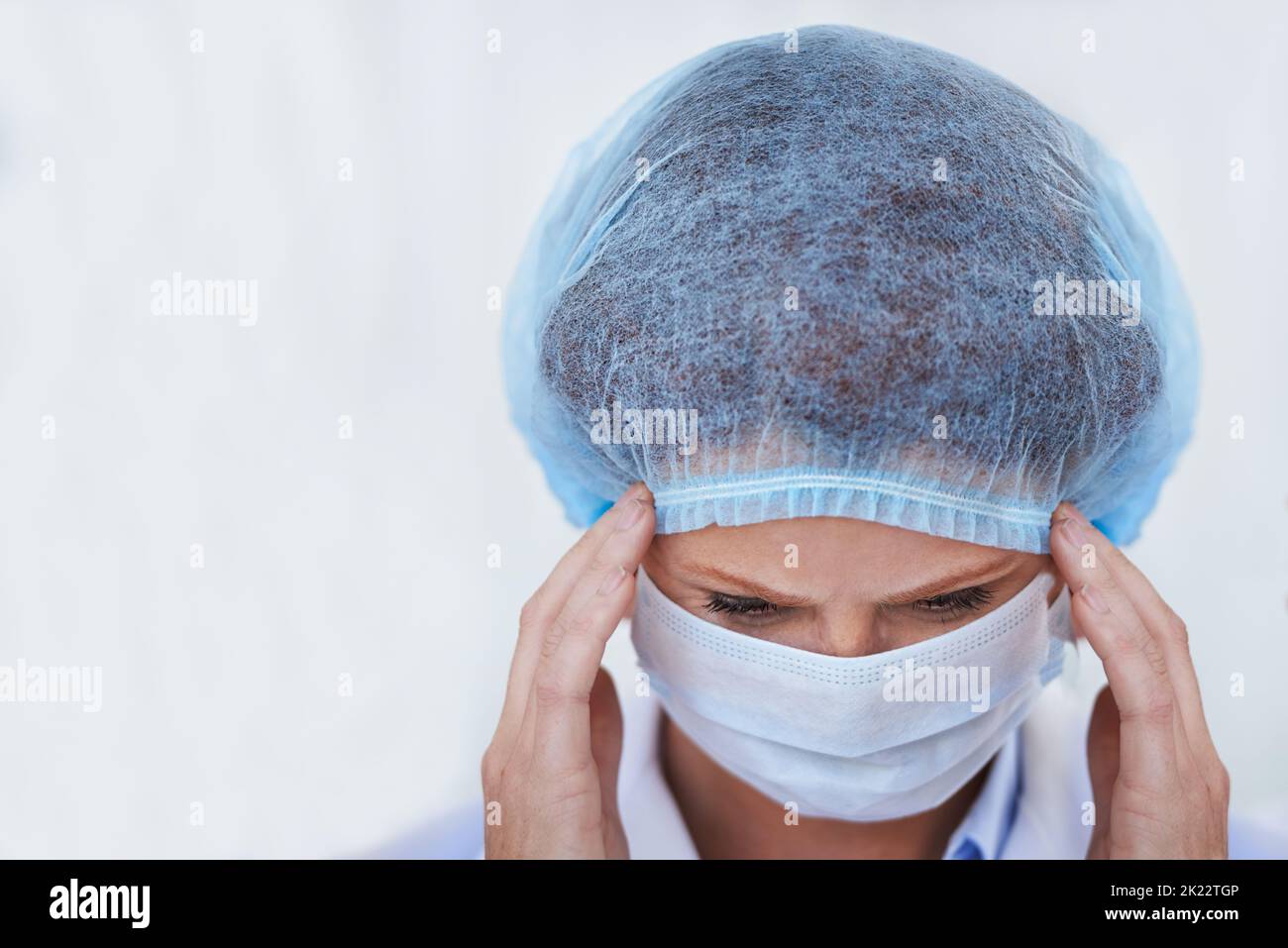 Staying focused for the big operation ahead. a female surgeon wearing a surgical cap and mask. Stock Photo