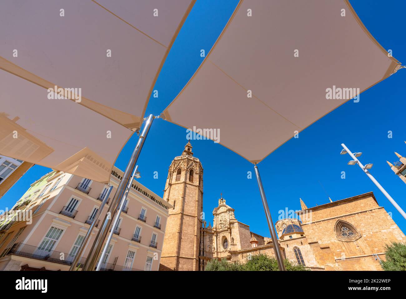 Vibrant Valencia cityscape with the City Cathedral and its famous bell tower known as Micalet or Miguelete against blue sky Stock Photo