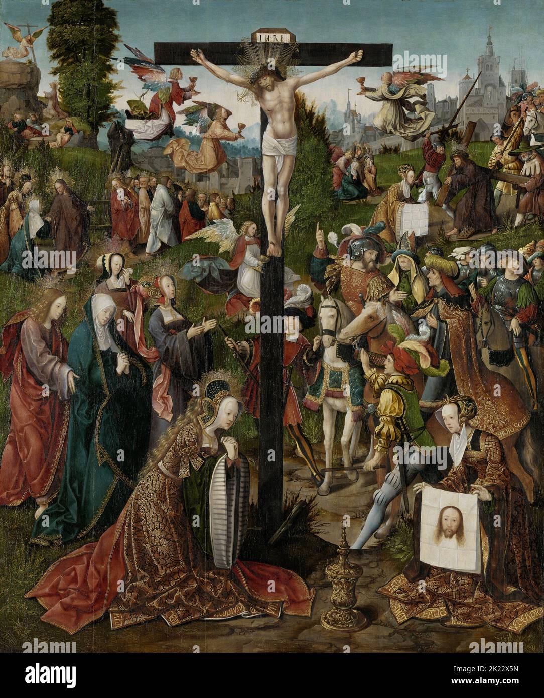 Netherlands: 'The Crucifixion'. Oil on panel painting by Jacob Cornelisz van Oostsanen (c. 1472/1477-1533), c. 1507-1510.  In this famous scene from the New Testament of the Christian Bible, Jesus Christ is crucified. He is nailed to a cross inscribed with the initials ‘INRI’—Iesus Nazerenus, Rex Iudaeorum’, meaning ‘Jesus of Nazareth, King of the Jews’—signifying the Romans’ ridicule of Him.  Angels fly nearby, collecting Jesus’ blood in their goblets. At the foot of the cross, richly dressed and with a halo around her flowing golden hair, Mary Magdalene prays. Stock Photo