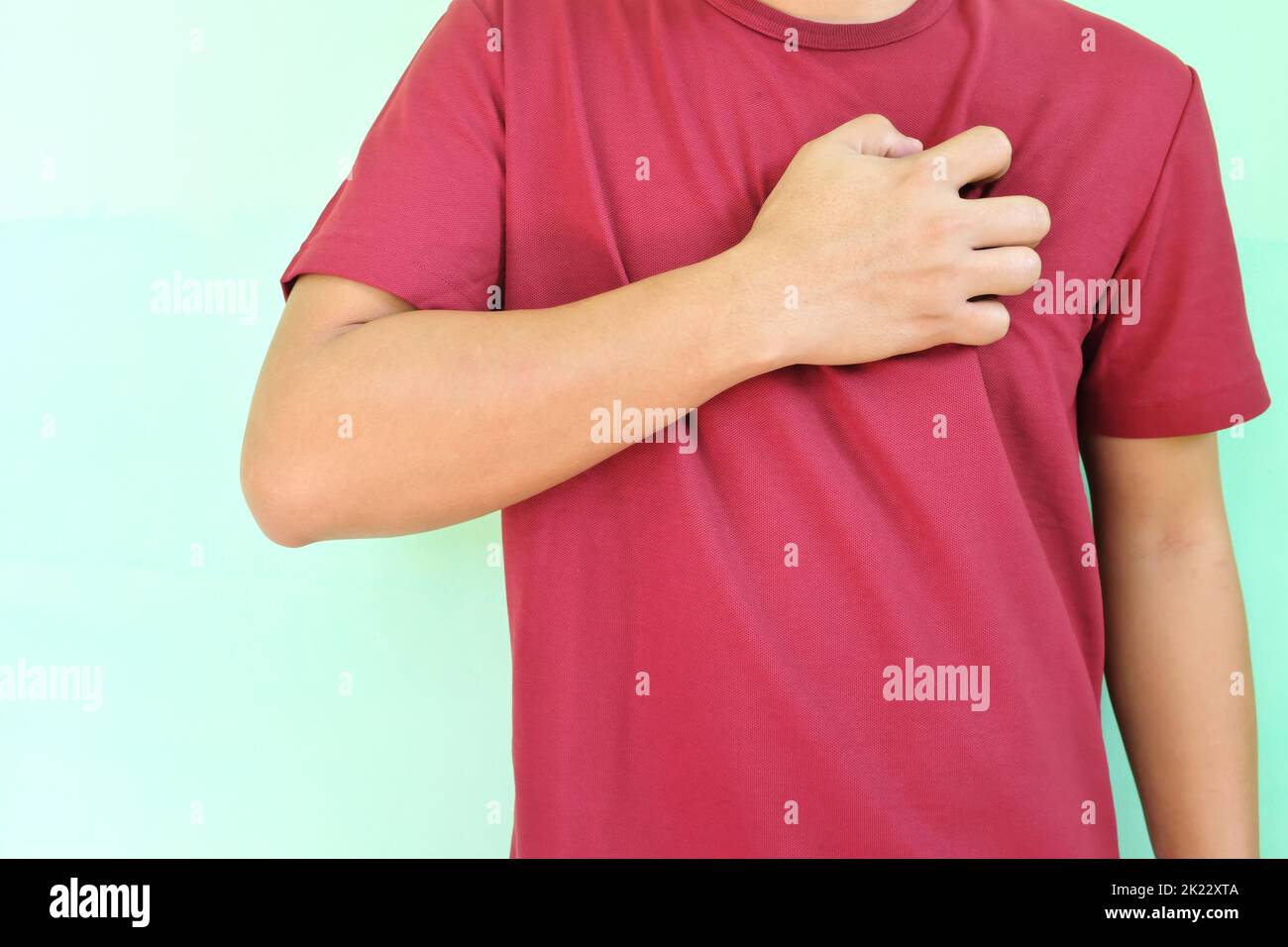 Heart pain, attack, ache, and heartburn concept. Young Asian man