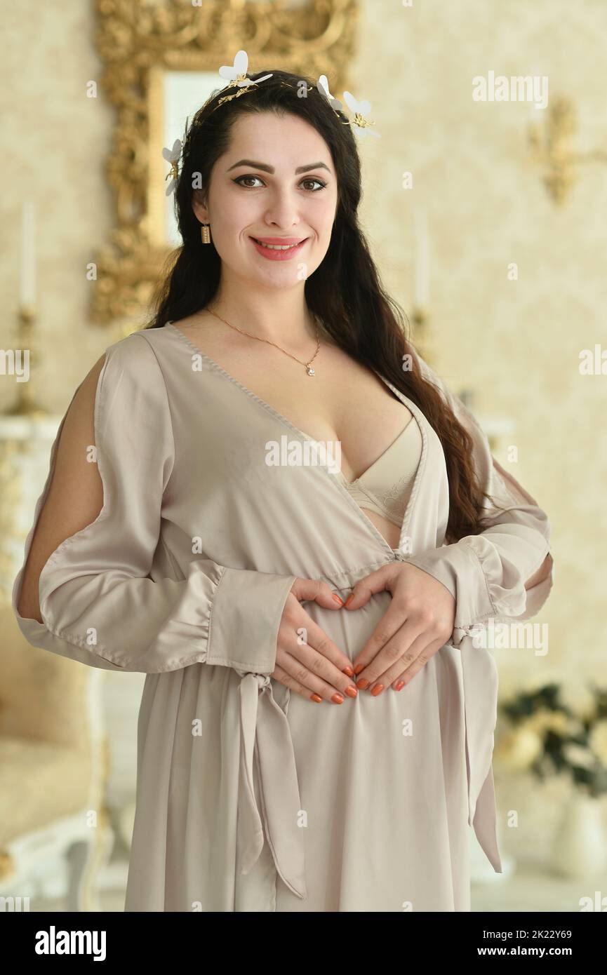 Portrait of a beautiful pregnant woman in a room  Stock Photo