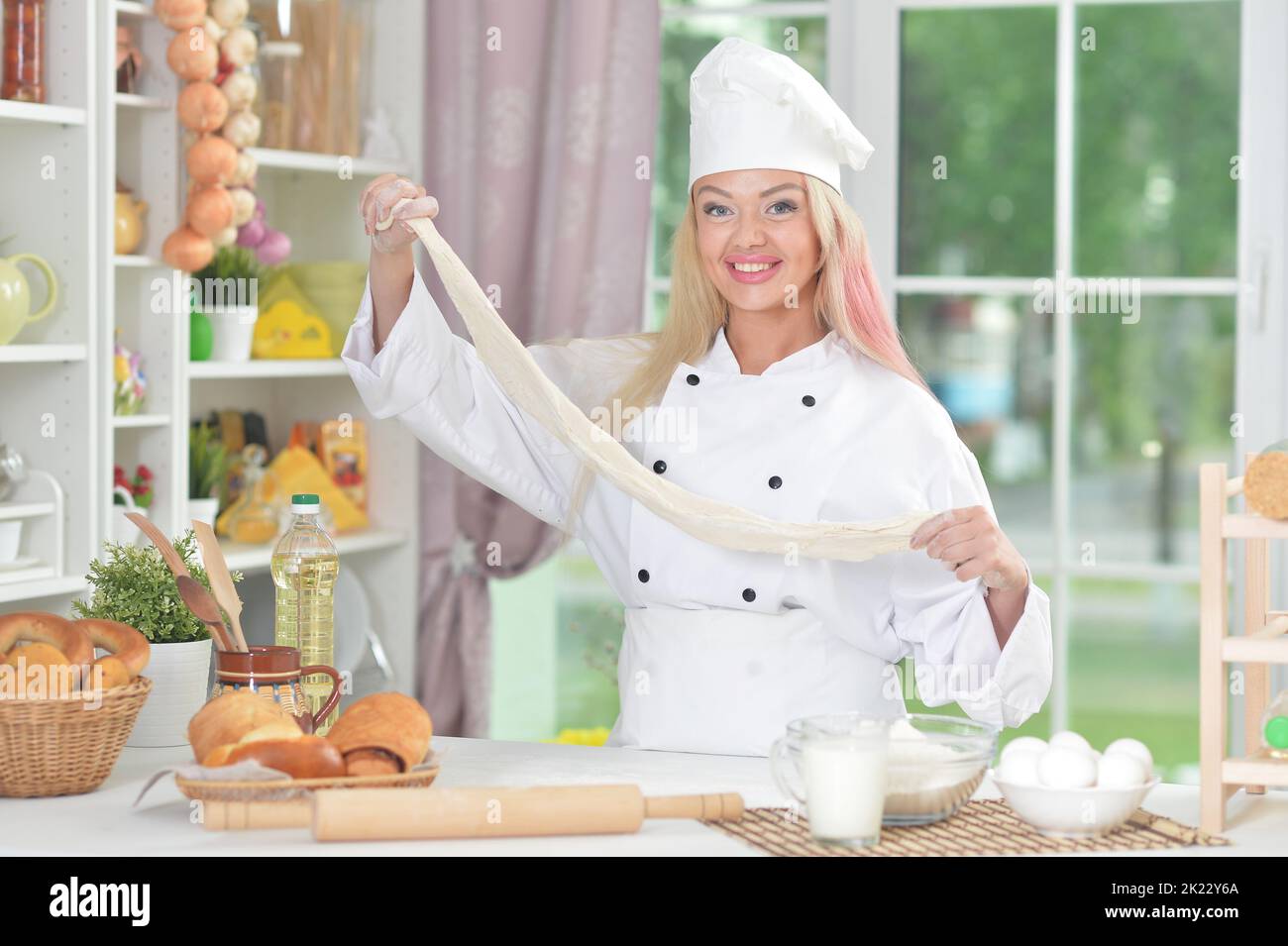 Young woman cooking healthy food in kitchen Stock Photo