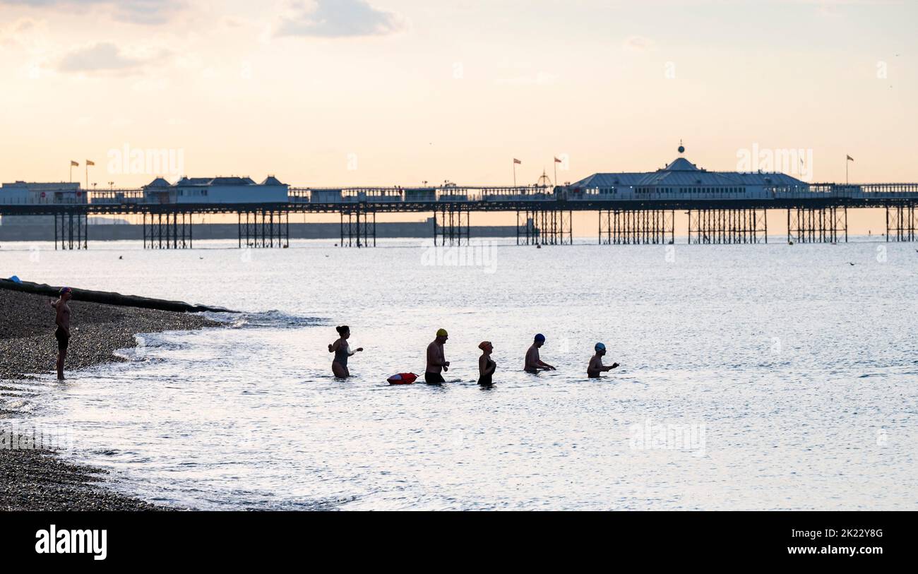 Brighton UK 22nd September 2022 - Early morning sea swimmers in Brighton enjoy the bright sunny but cool weather as more unsettled conditions are forecast for the next few days .   . : Credit Simon Dack / Alamy Live News Stock Photo
