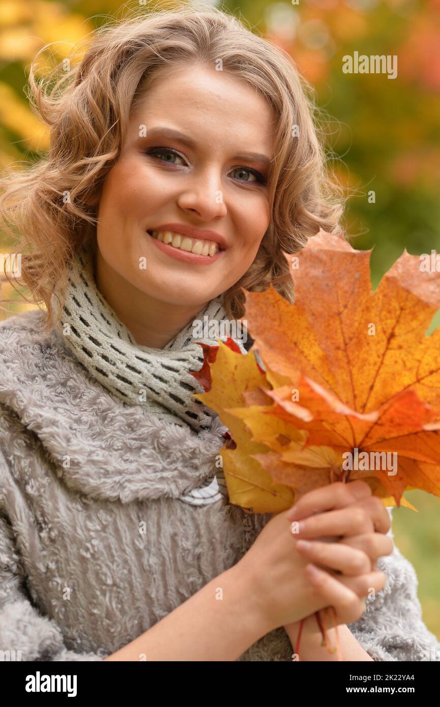 Beautiful woman walking in the park in autumn Stock Photo