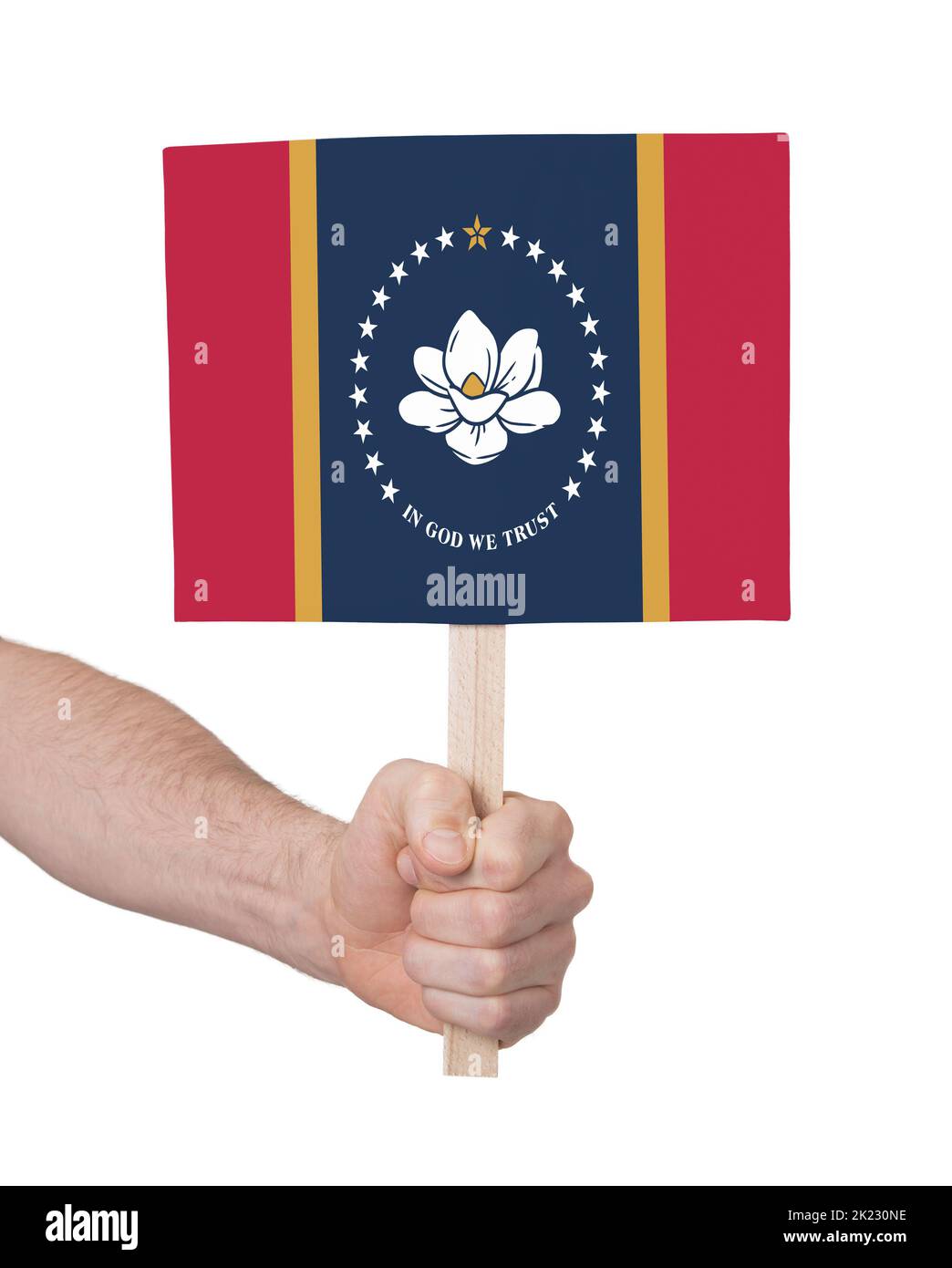 Hand holding banner on wood stick, isolated - Flag of Mississippi Stock Photo