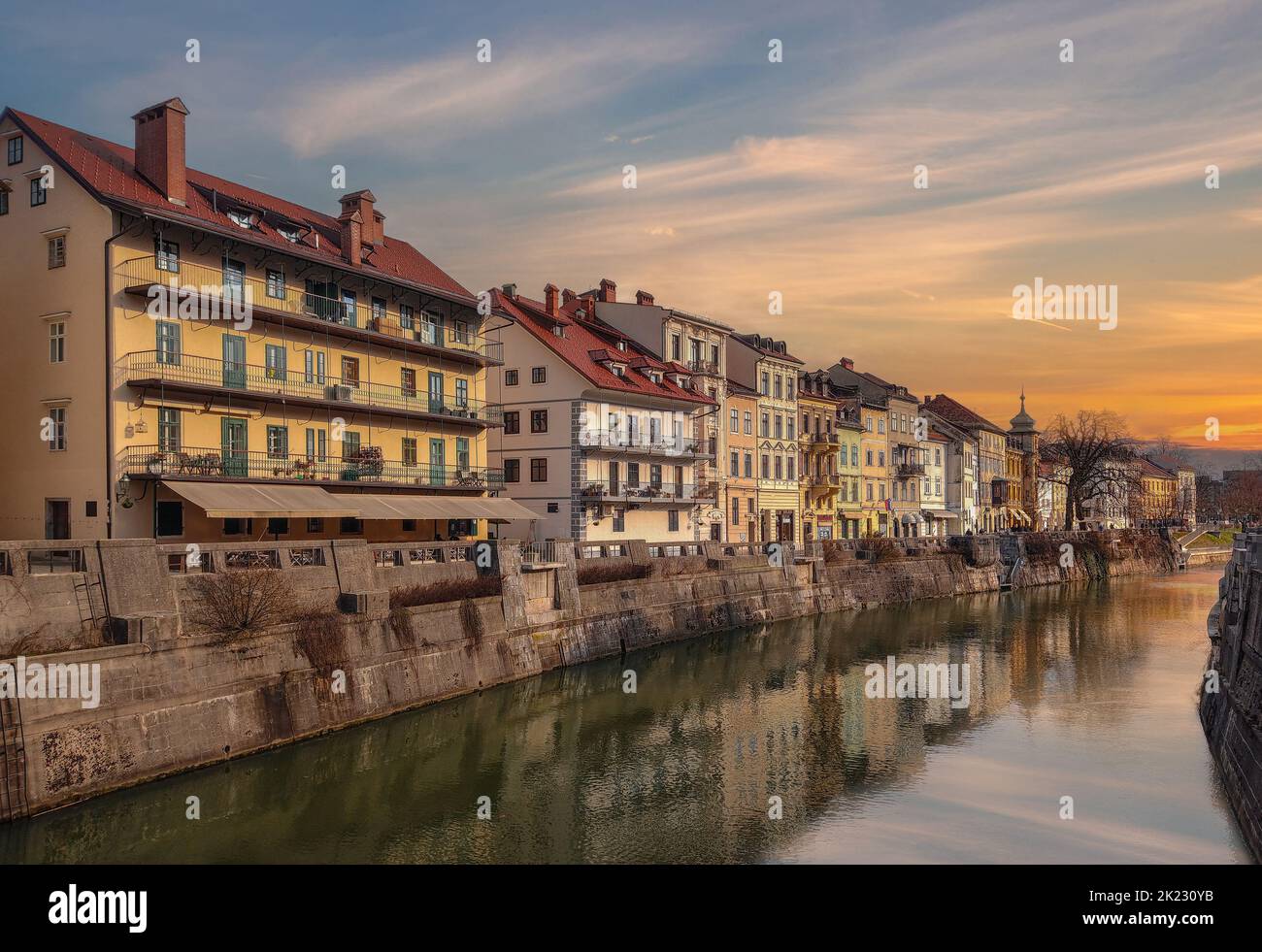 Ljubljana, Slovenia - Beautiful sunset over the old town of Ljubljana with Ljubljanica river and traditional Slovenian houses on a sunny winter aftern Stock Photo