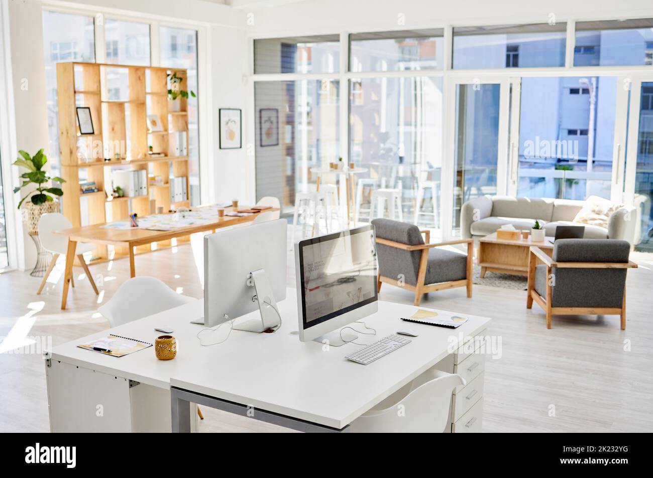 Empty office room, workplace or interior with an arranged desk, computers and furniture. Corporate organized work space, business company working area Stock Photo
