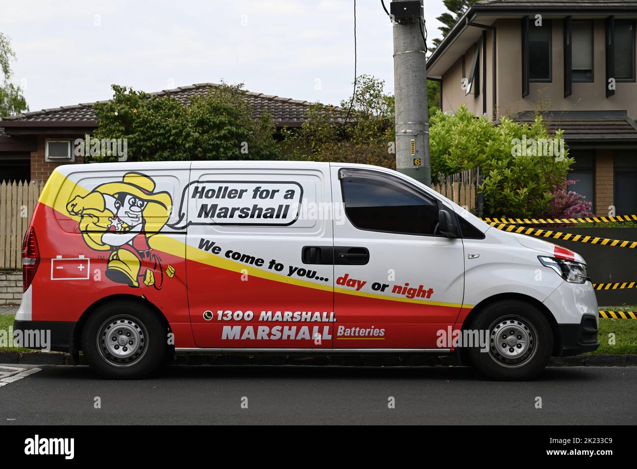 Side view of a Marshall Batteries van, a Hyundai iLoad, parked in a suburban street during an overcast day Stock Photo