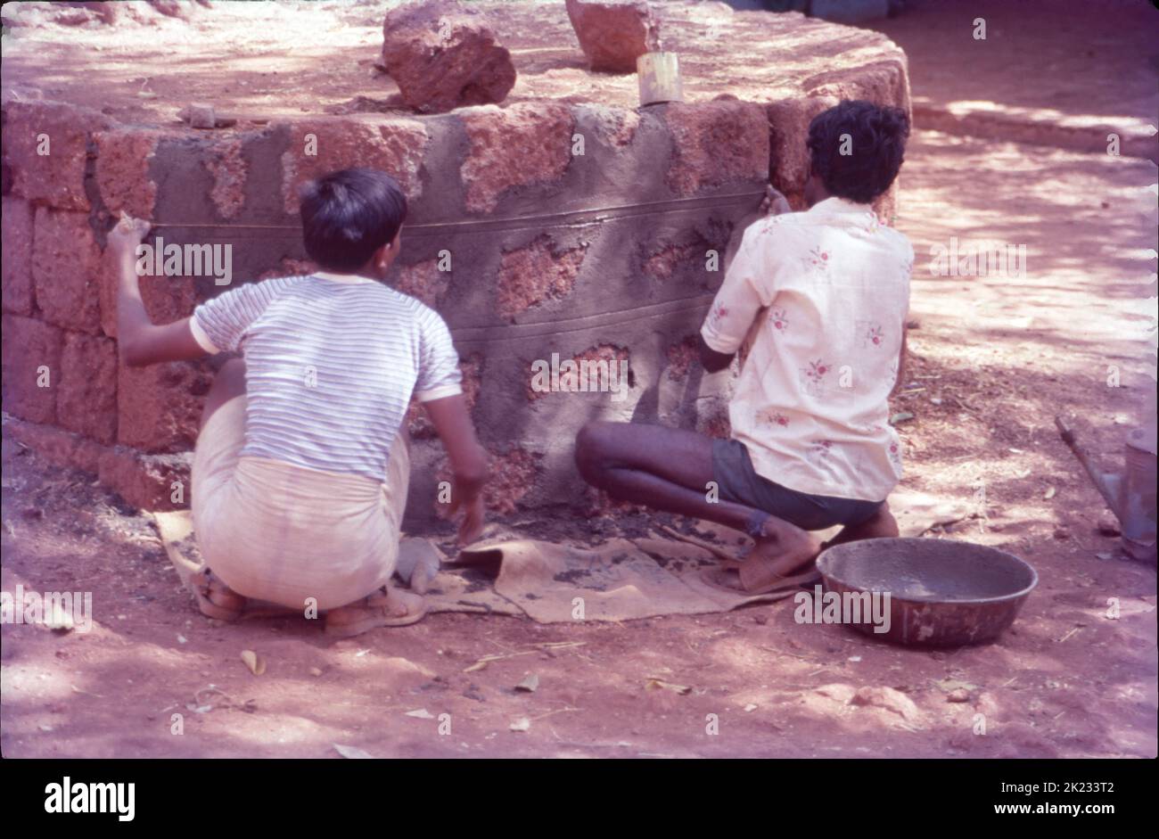 Mason Repairing Platform Around Tree, Matheran, Maharashtra Stock Photo