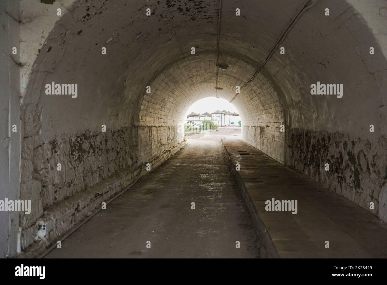 Dark tunnel under highway to beach.Spain. Stock Photo