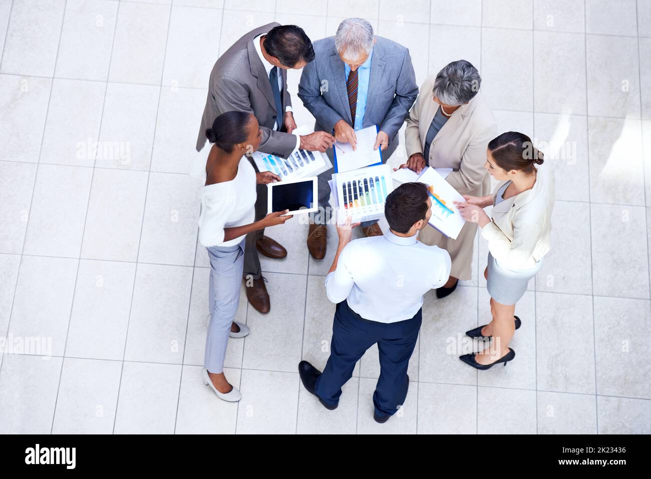 Analyzing the quarterly results. a group of diverse businesspeople discussing paperwork in a meeting. Stock Photo