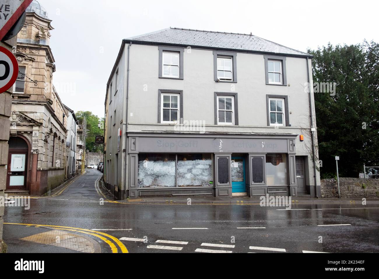 Exterior view of closed cafe shop with opaque whited out windows and