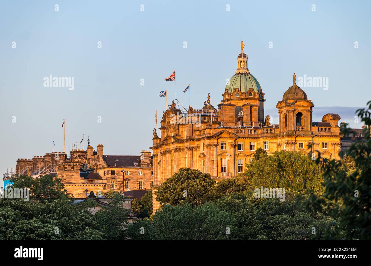 Grand building with copper dome former Bank of Scotland headquarters  flying saltire and Union Jack national flags, Edinburgh, Scotland, UK Stock Photo