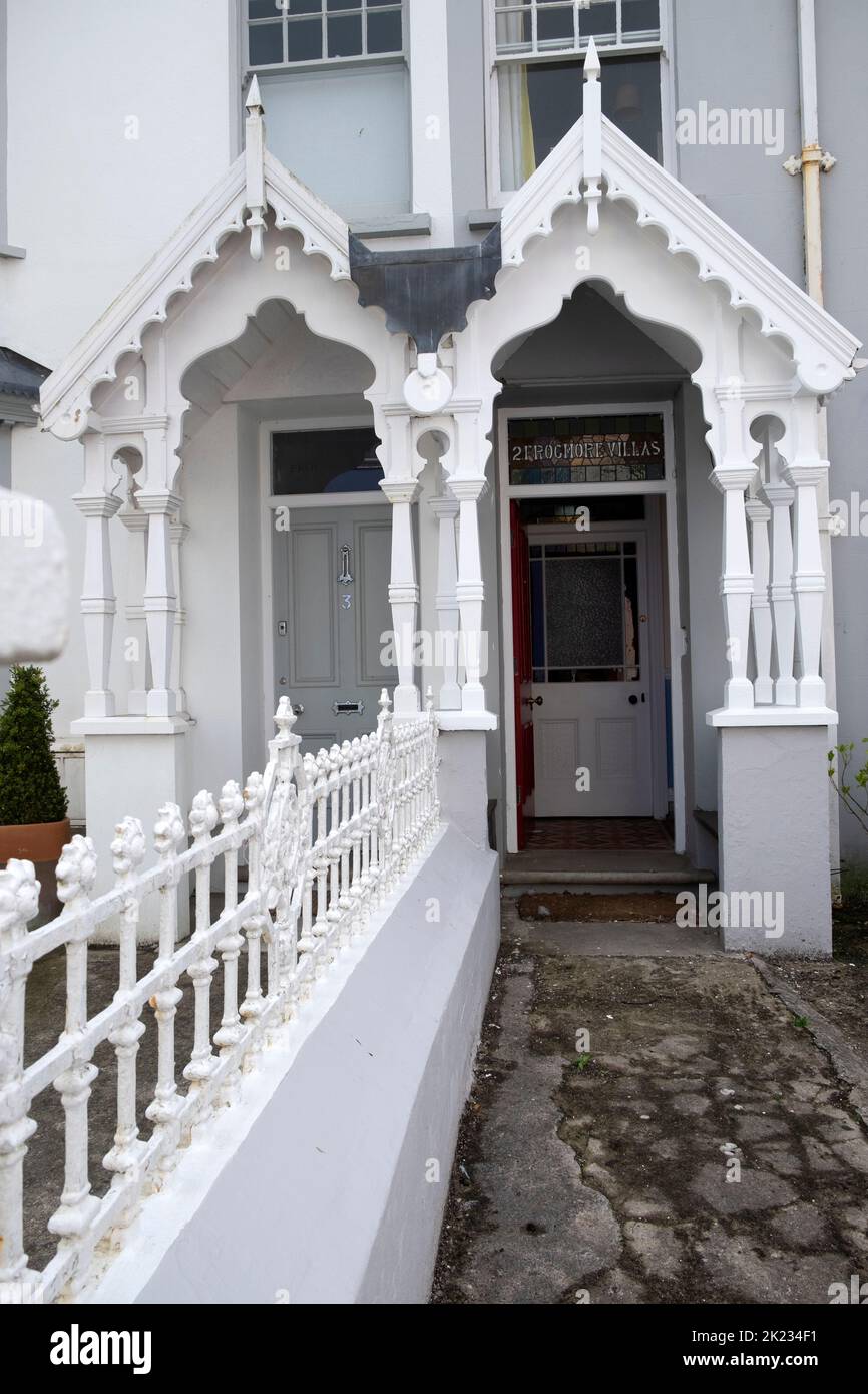 Ornate front entrance porch railing on front of old houses in Tenby Pembrokeshire Wales UK Stock Photo