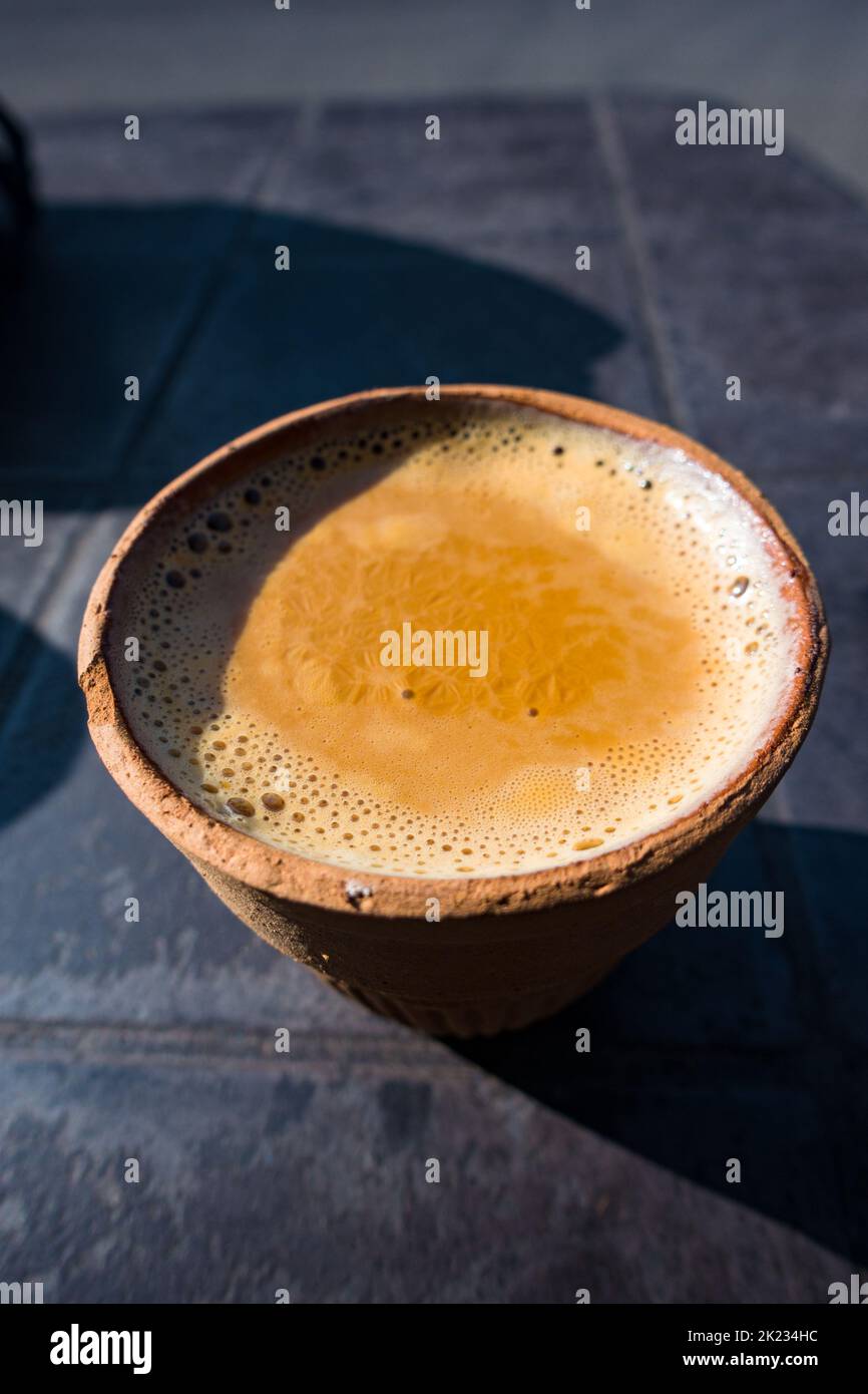 Hot Indian spiced tea served in a traditional clay pot glass called Kulhad. Outdoor roadside tea shops in Uttarakhand , India. Stock Photo