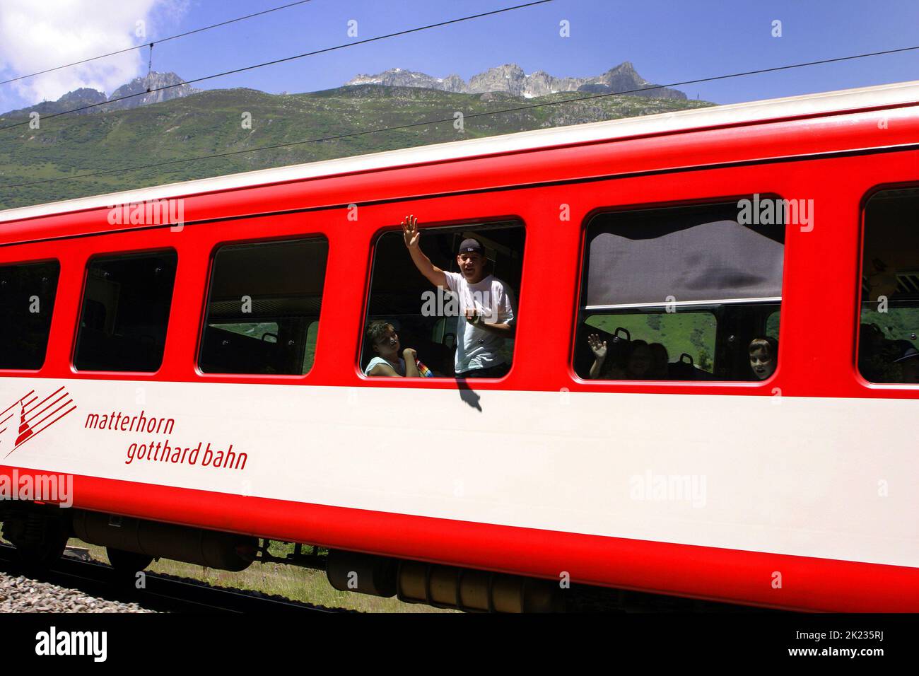Man waving from the Matterhorn Gotthard Bahn train, Swiss Alps, Switzerland Stock Photo