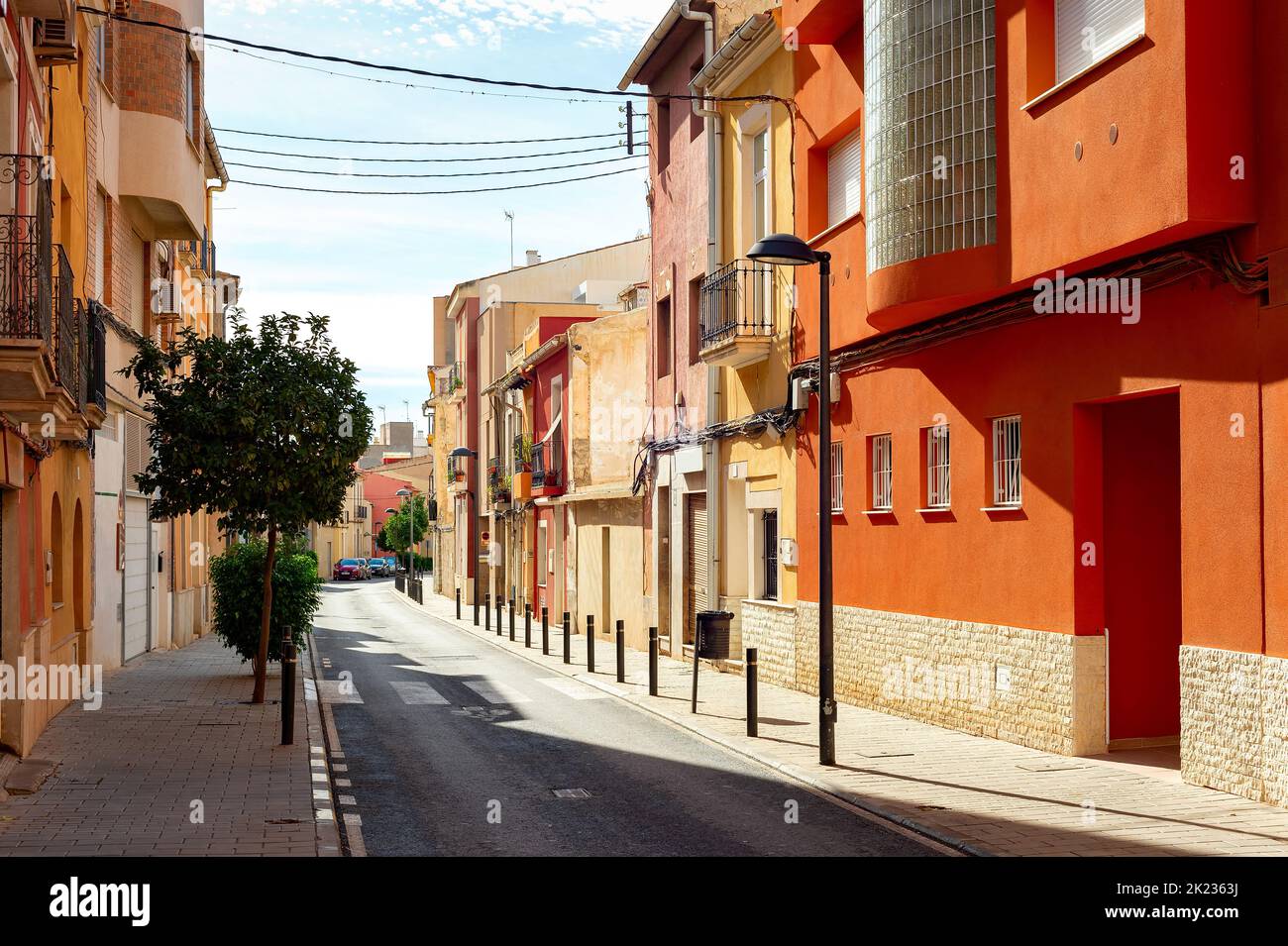 Street road with typical architecture of Mediterranean region in bright sunny day, Alicante, Spain Stock Photo