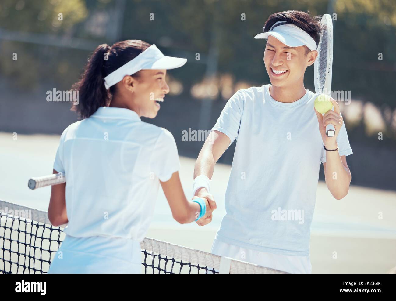 Tennis, handshake and teamwork with a health athlete or coach shaking hands on a sports court
