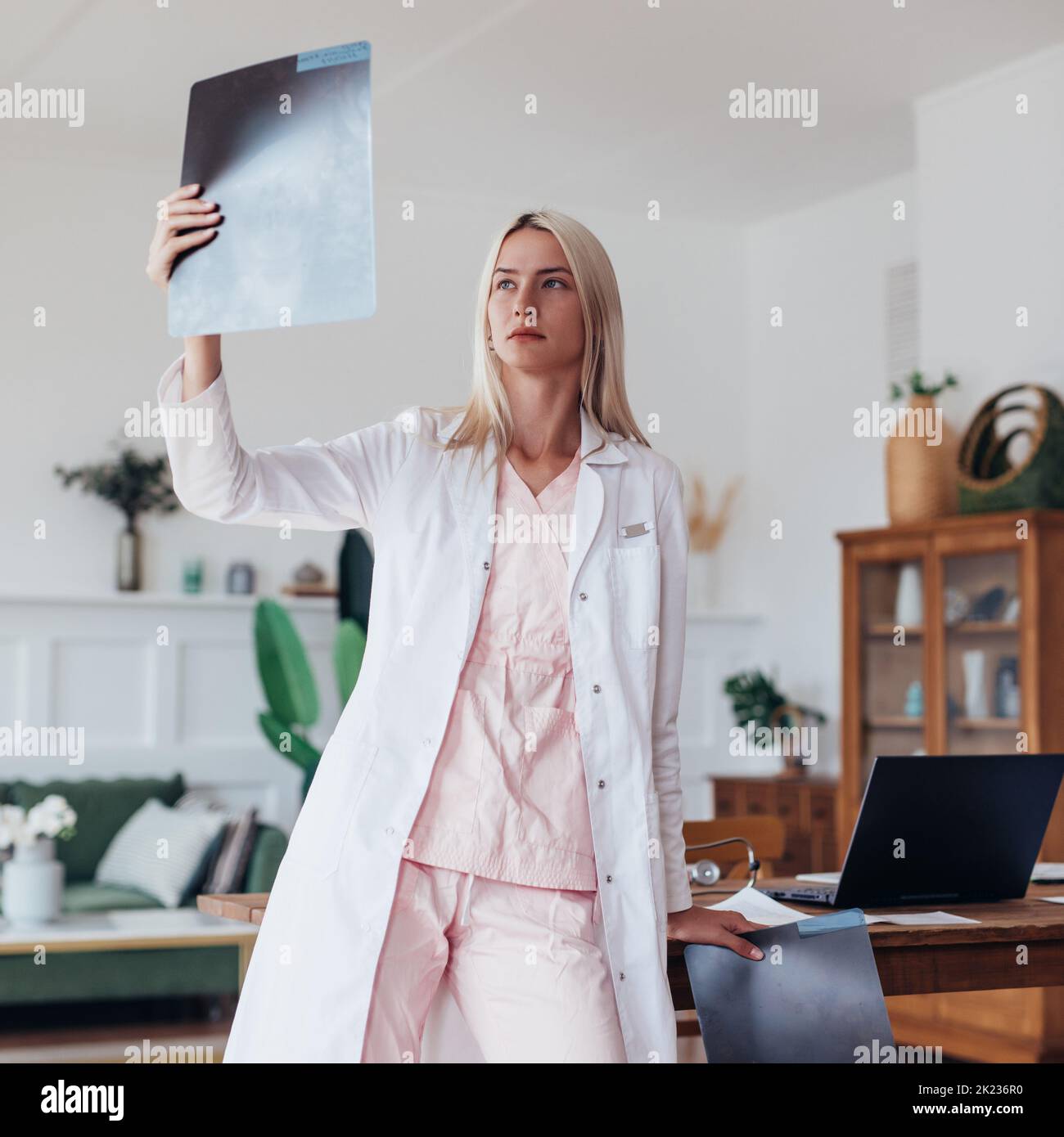 Woman doctor looking at an X-ray image in the office. Stock Photo