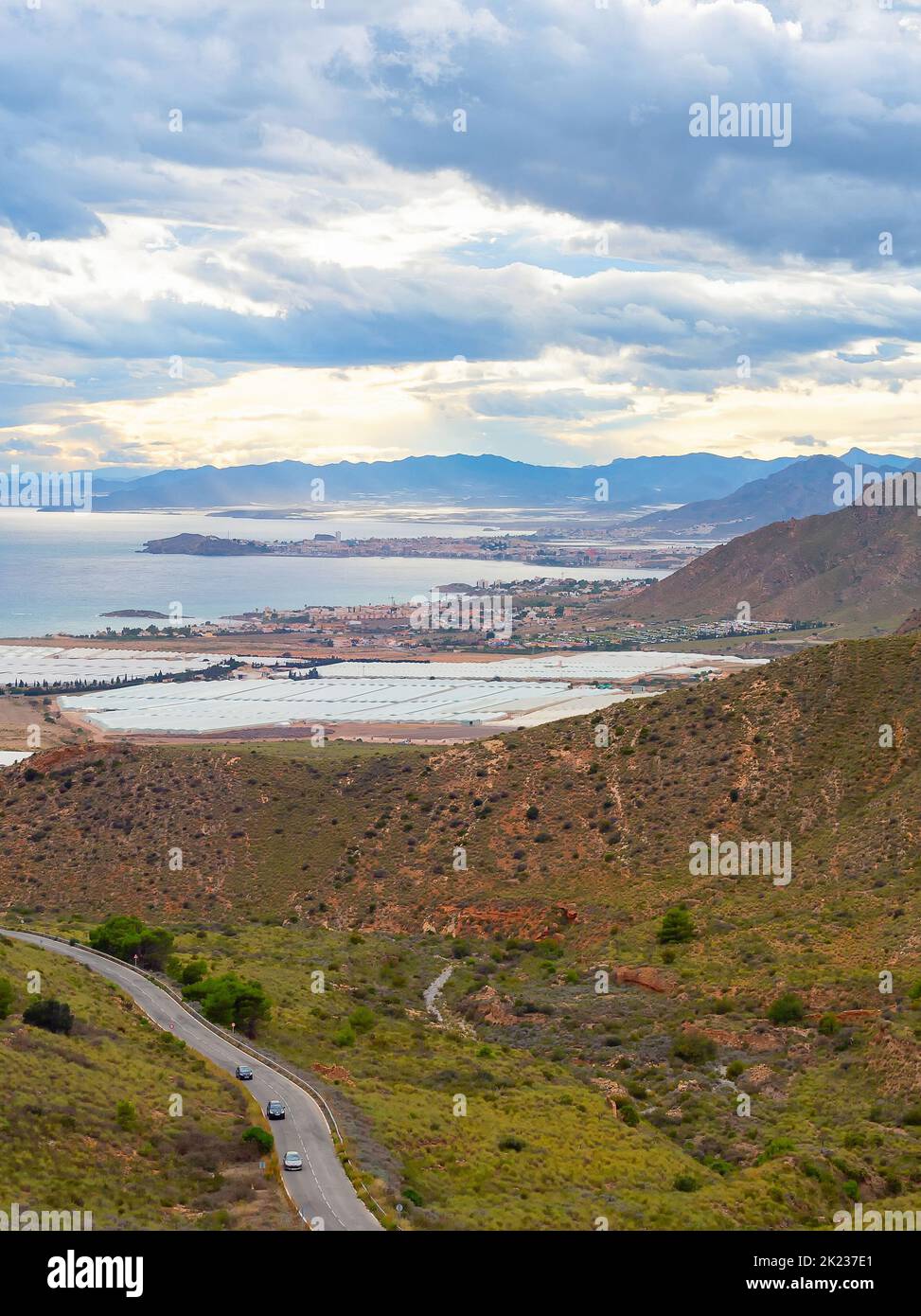 Landscape with mountains and village at seaside view under stormy sky, south of Spain Stock Photo