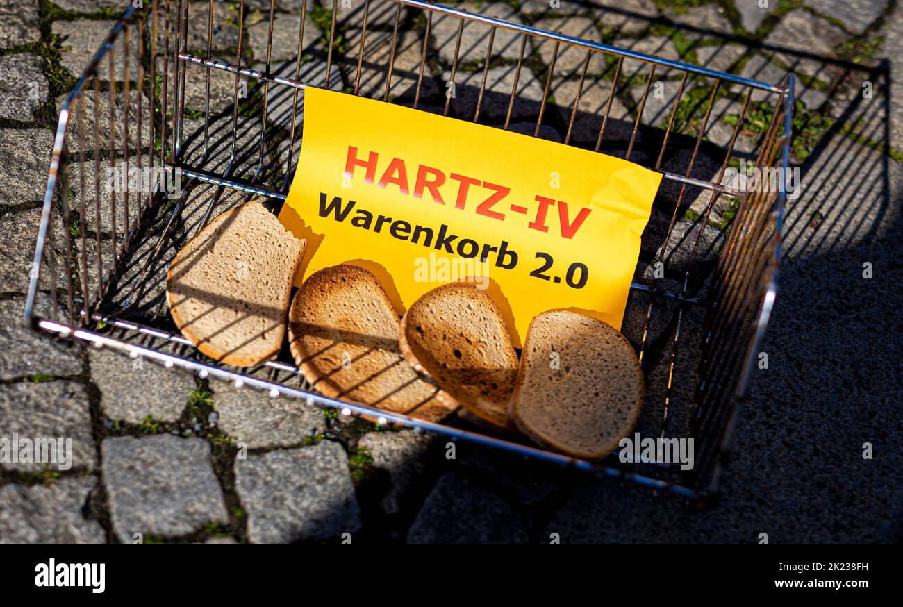 Hanover, Germany. 22nd Sep, 2022. The words 'Hartz-IV Warenkorb 2.0' (Hartz IV shopping basket 2.0) can be read on a piece of paper lying next to slices of bread during the campaign 'Wahlzeit? - Mahlzeit!' ('Election Time? Meal Time!') campaign by the Lower Saxony State Poverty Conference in front of the state parliament. Credit: Moritz Frankenberg/dpa/Alamy Live News Stock Photo