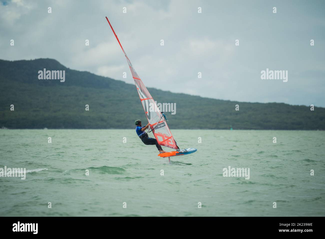 A man competes in a national windsurfing hydrofoil race at the