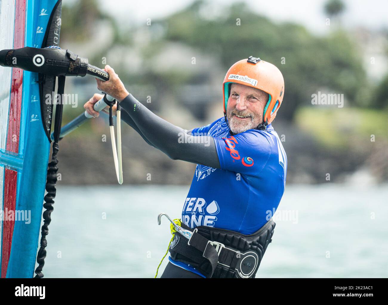 A retired senior man competes in a New Zealand national windsurfing