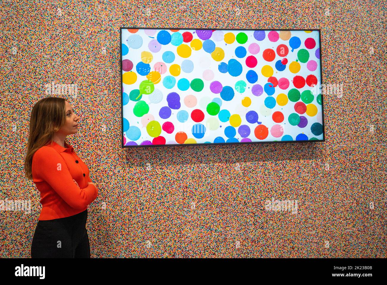 London UK. 22 September 2022.   A Newport staff member views works at the preview of 'The Currency' by Damien Hirst consisting of 10,000 NFTs corresponding to 10,000 unique physical artworks Hirst  created where collectors could keep the NFT or exchange it for the physical artwork. The exhibition runs from 23 September-30 October at Newport Street Gallery Lambeth and  artworks will be burned when the exhibition closes. Credit: amer ghazzal/Alamy Live News. Stock Photo