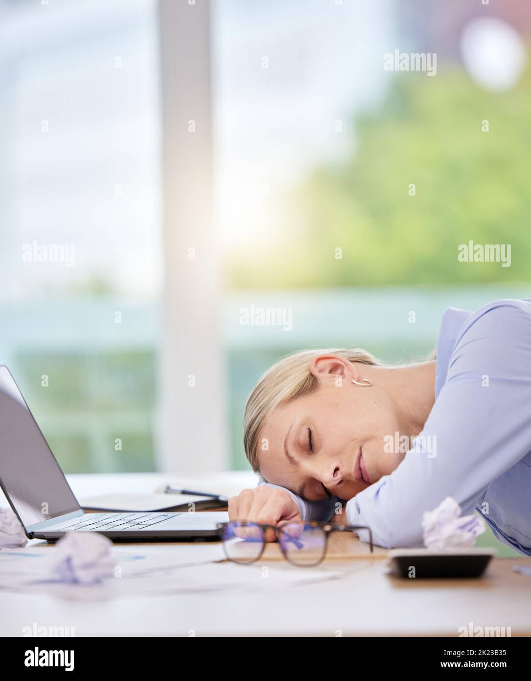 Sleep, burnout and tired with a business woman sleeping at her desk in
