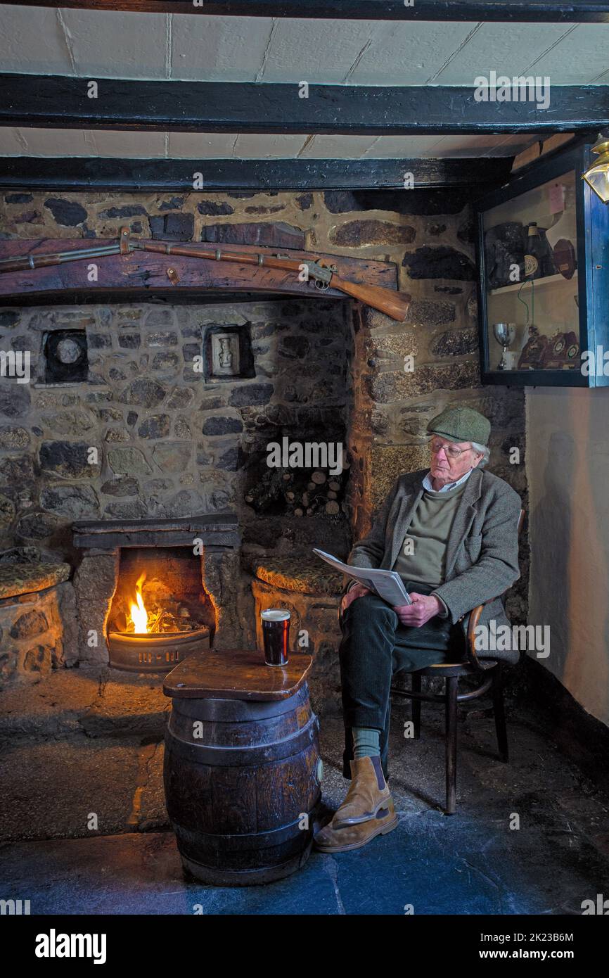 .Man sitting with a glas of pint in The Blue Anchor Inn in Helston , Cornwall, England . Stock Photo