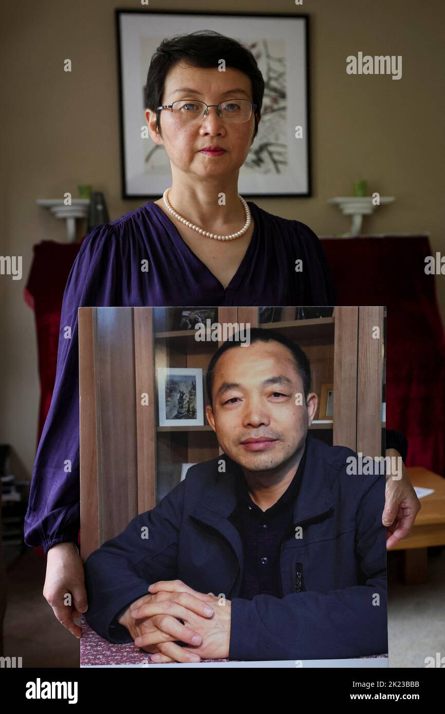Sophie Luo Shengchun, the wife of jailed Chinese human rights lawyer, Ding Jiaxi, poses with a photo of him at her home in Alfred, New York, U.S., July 28, 2022.  To match Special Report CHINA-LAWYERS/CRACKDOWN-MAINLAND.     REUTERS/Brendan McDermid Stock Photo
