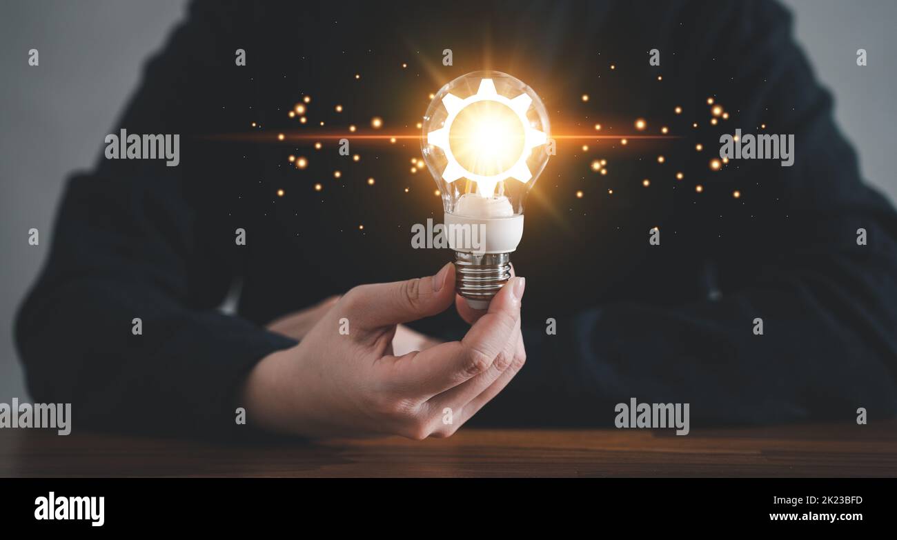 Innovation design concept. Hand holding light bulb for new idea brain ...