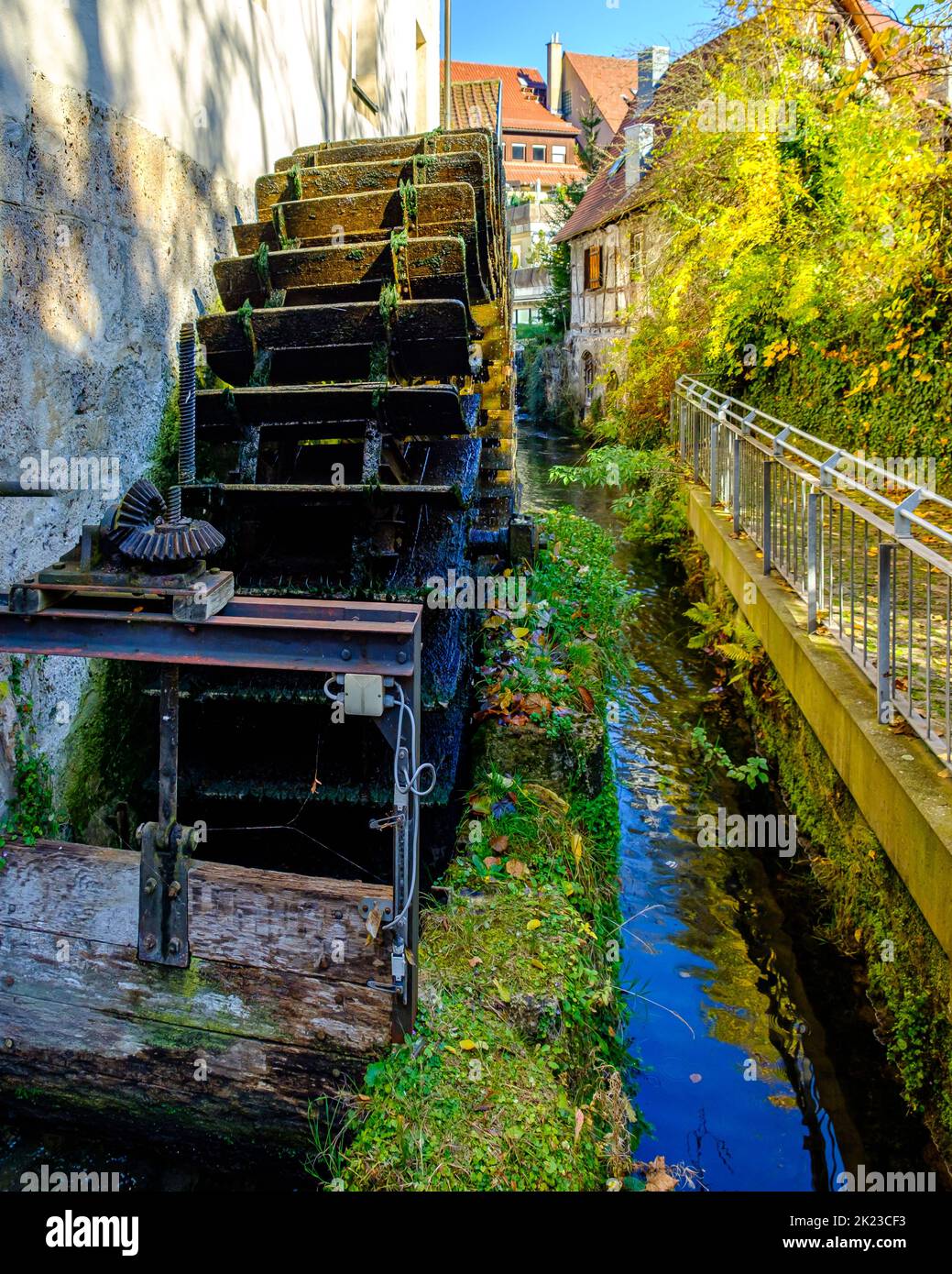 Symbolic image of a historic mill wheel and the concept of water energy and sustainability. Stock Photo