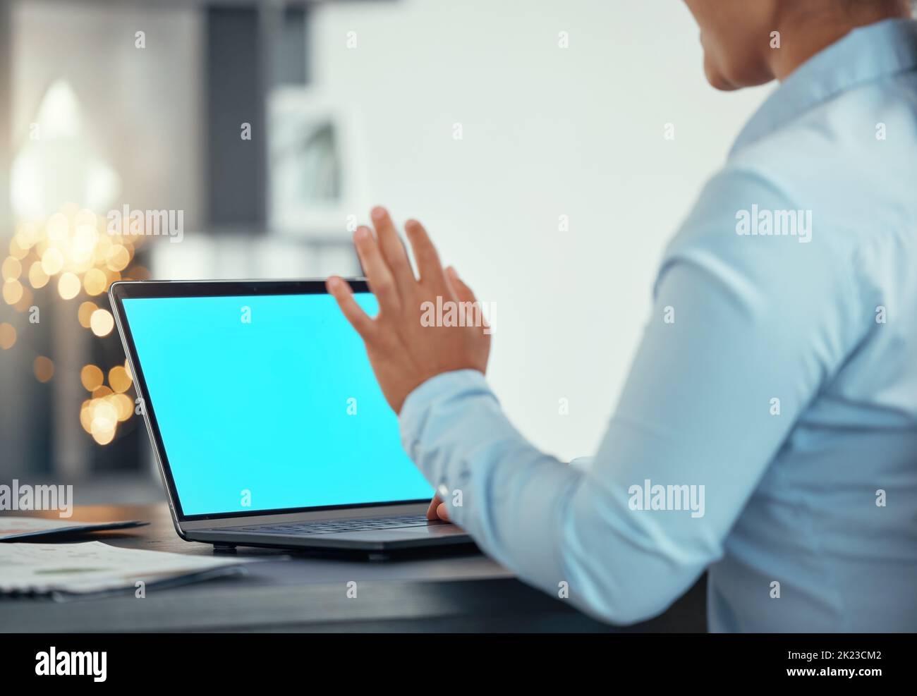 Green screen on laptop, a woman uses hand to test video quality and starts streaming meeting with 5g technology. Helping global online communication Stock Photo