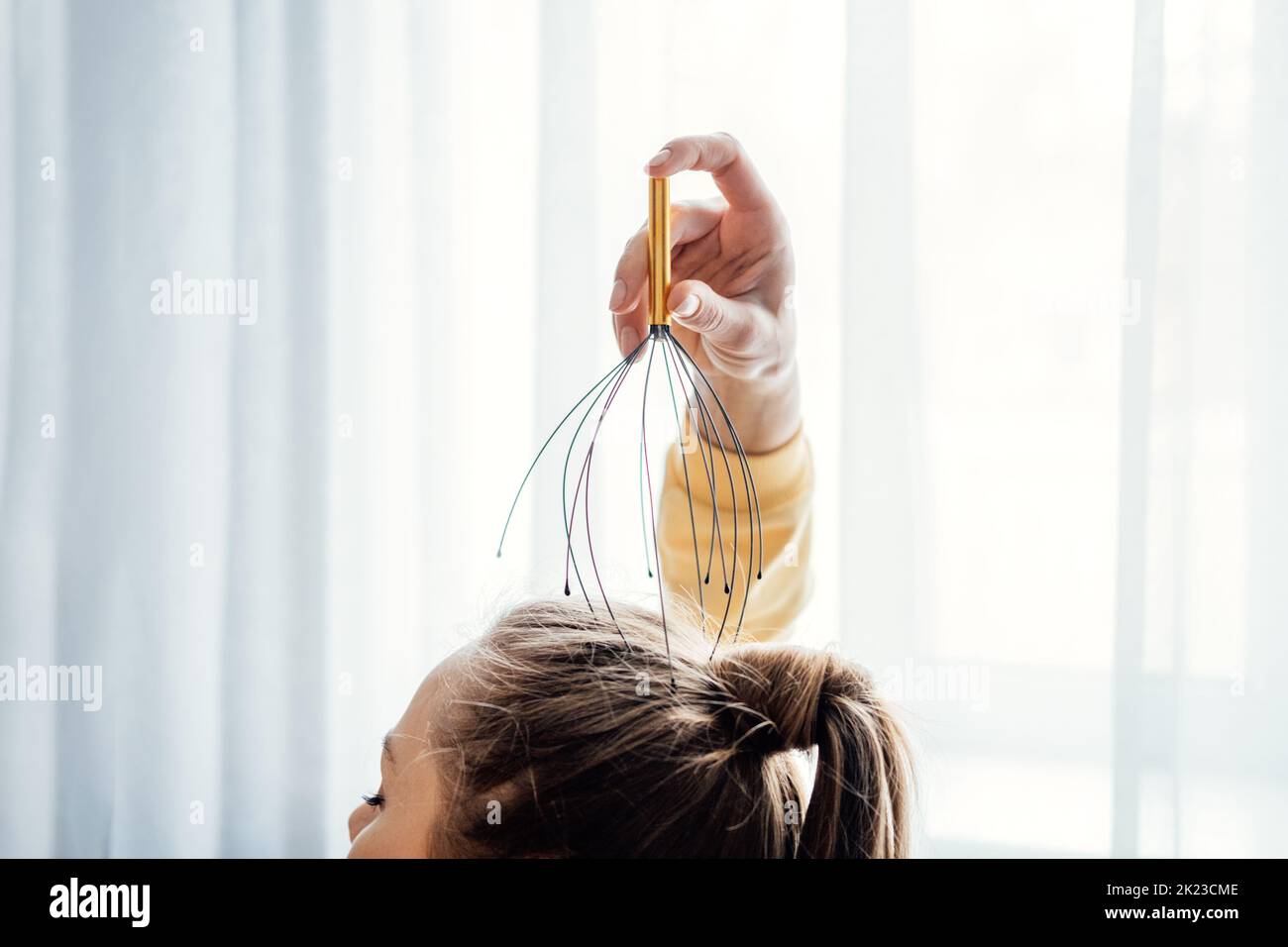 Female hand with Head Massager Scalp Scratcher with Fingers. Self