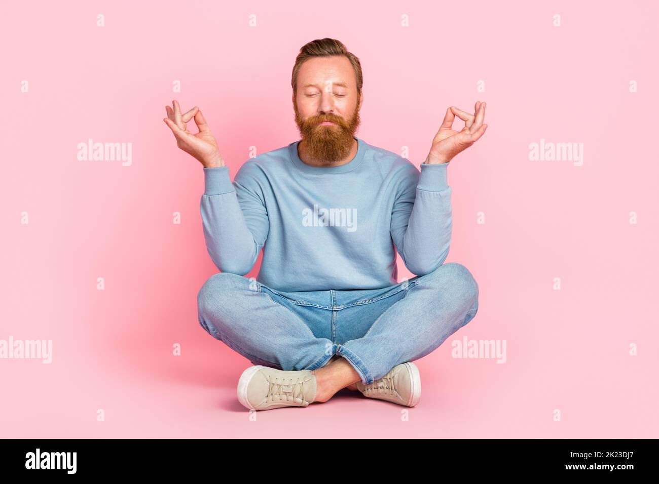 Full body portrait of content young man sitting floor closed eyes ...