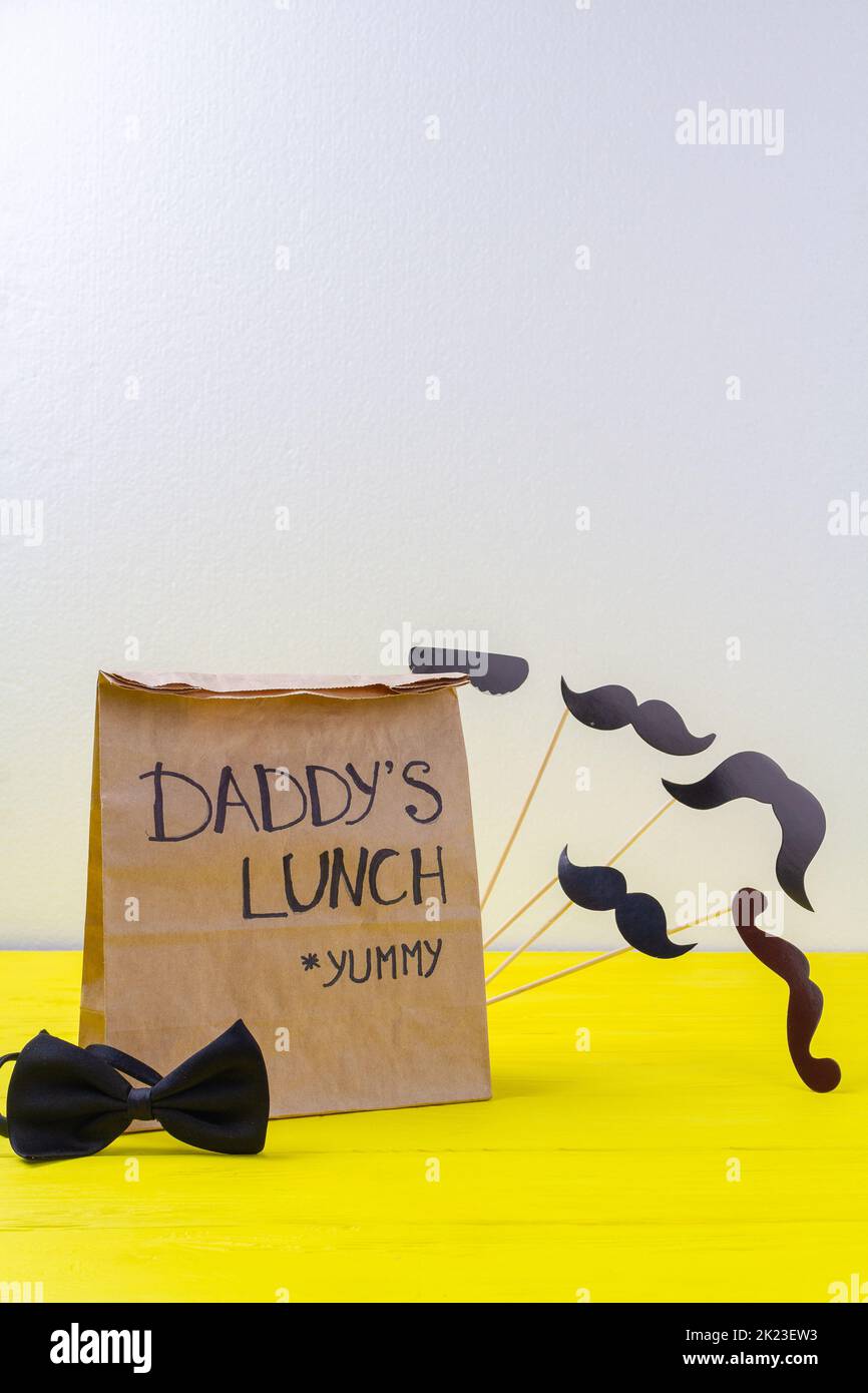 Vertical shot of paper bag and copy space. Lunch for loving daddy. Stock Photo