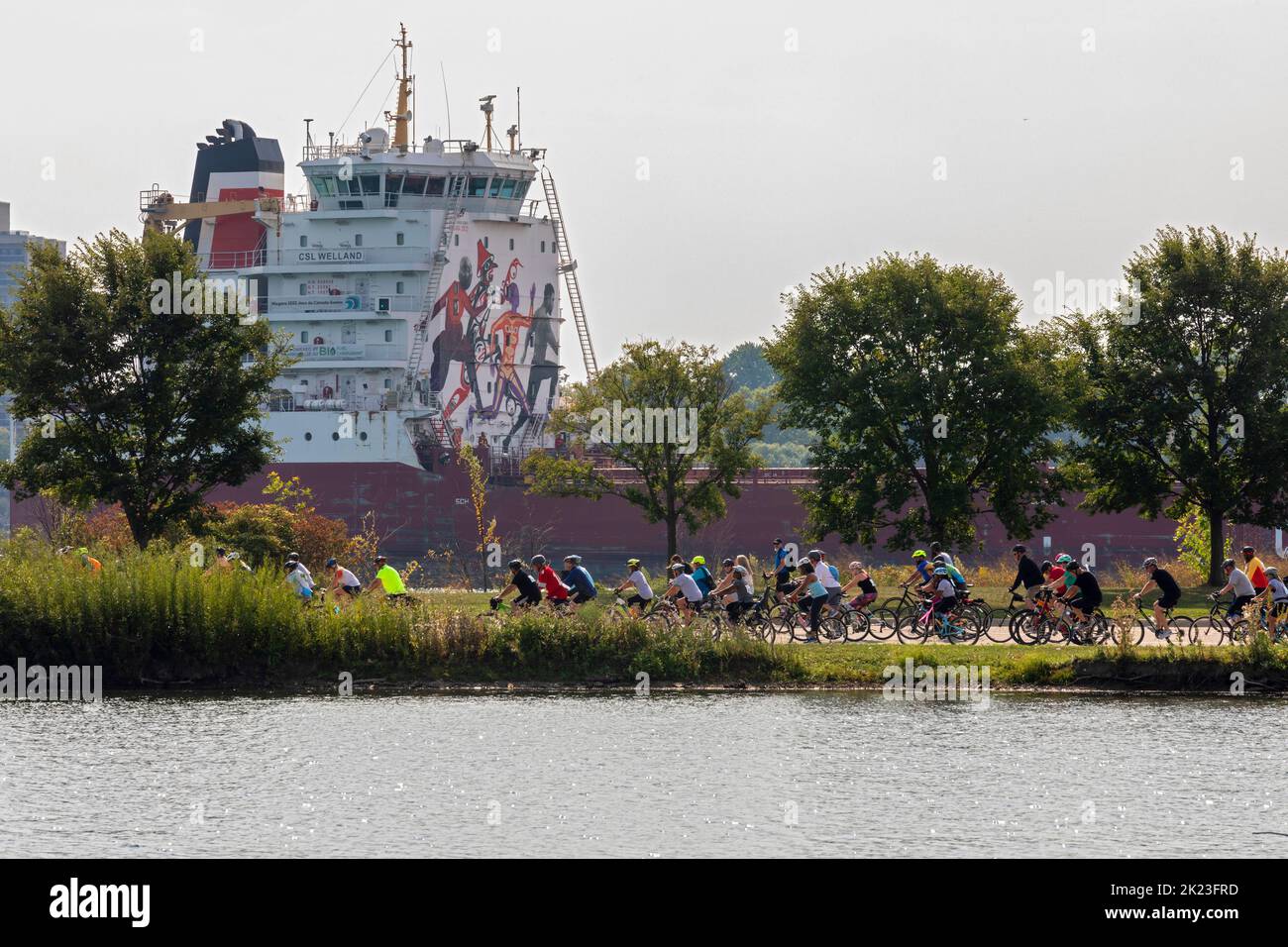 Detroit, Michigan - Thousands of riders joined the 2022 Tour de Troit. As the Tour rode on Belle Isle, Canada Steamship Line's CSL Welland passed on t Stock Photo