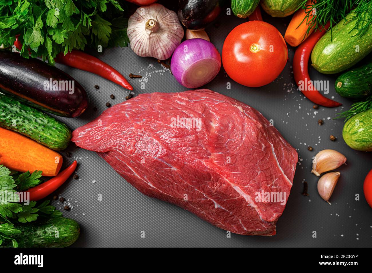 Red meat and vegetables on a cutting board. Stock Photo