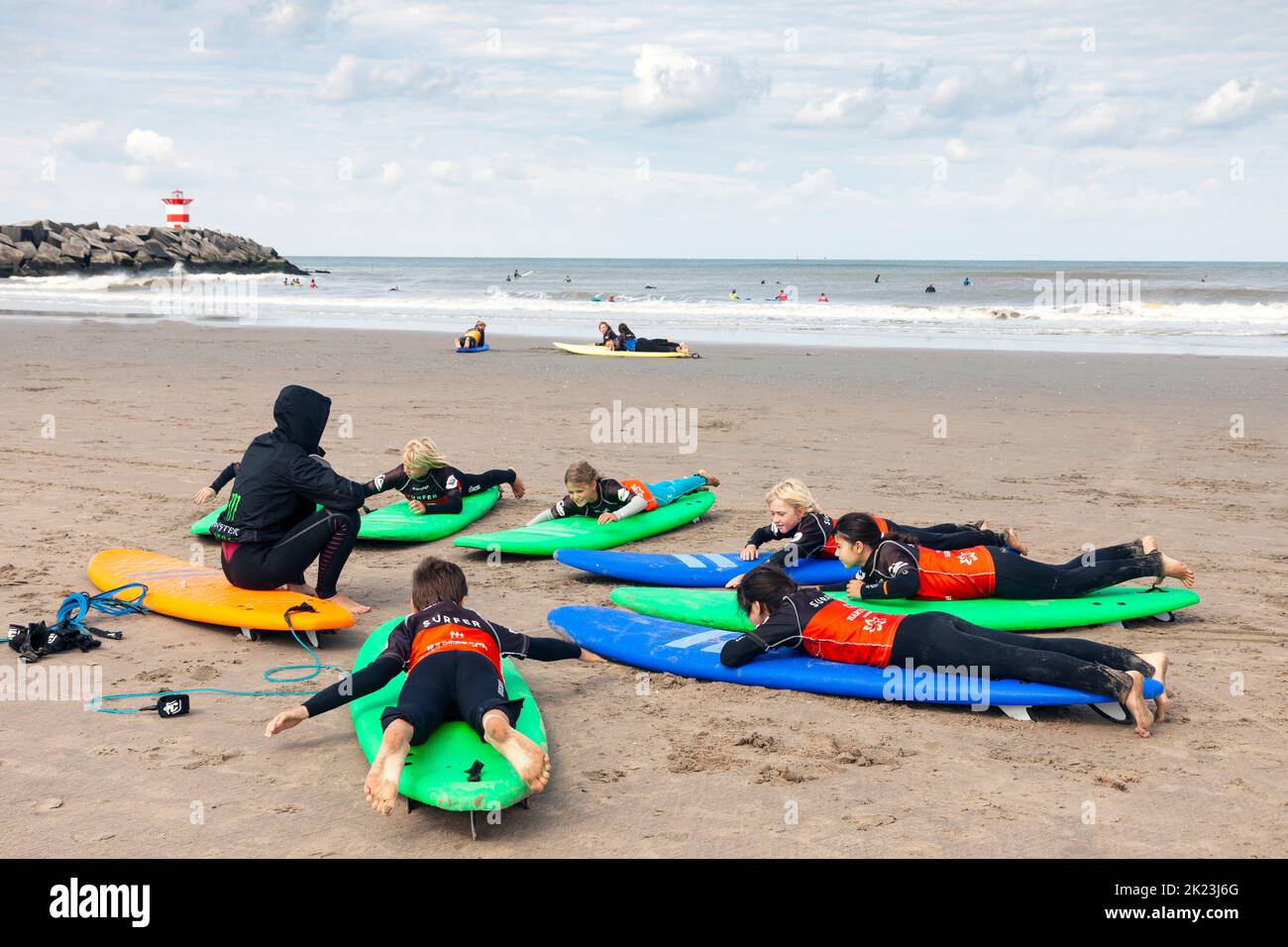 Scheveningen, Netherlands - 26 August, 2018: Group of children lying on surfboards during surfing training on the beach in Scheveningen, The Netherlan Stock Photo