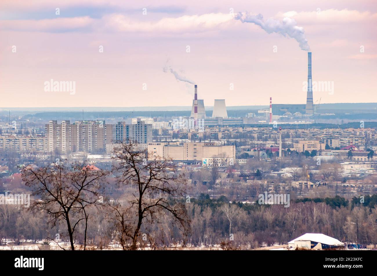 Panoramic view of the Kiev's left bank from the Park of Eternal Glory. Trees, buildings and factories with high smoking chimneys appear in the distanc Stock Photo