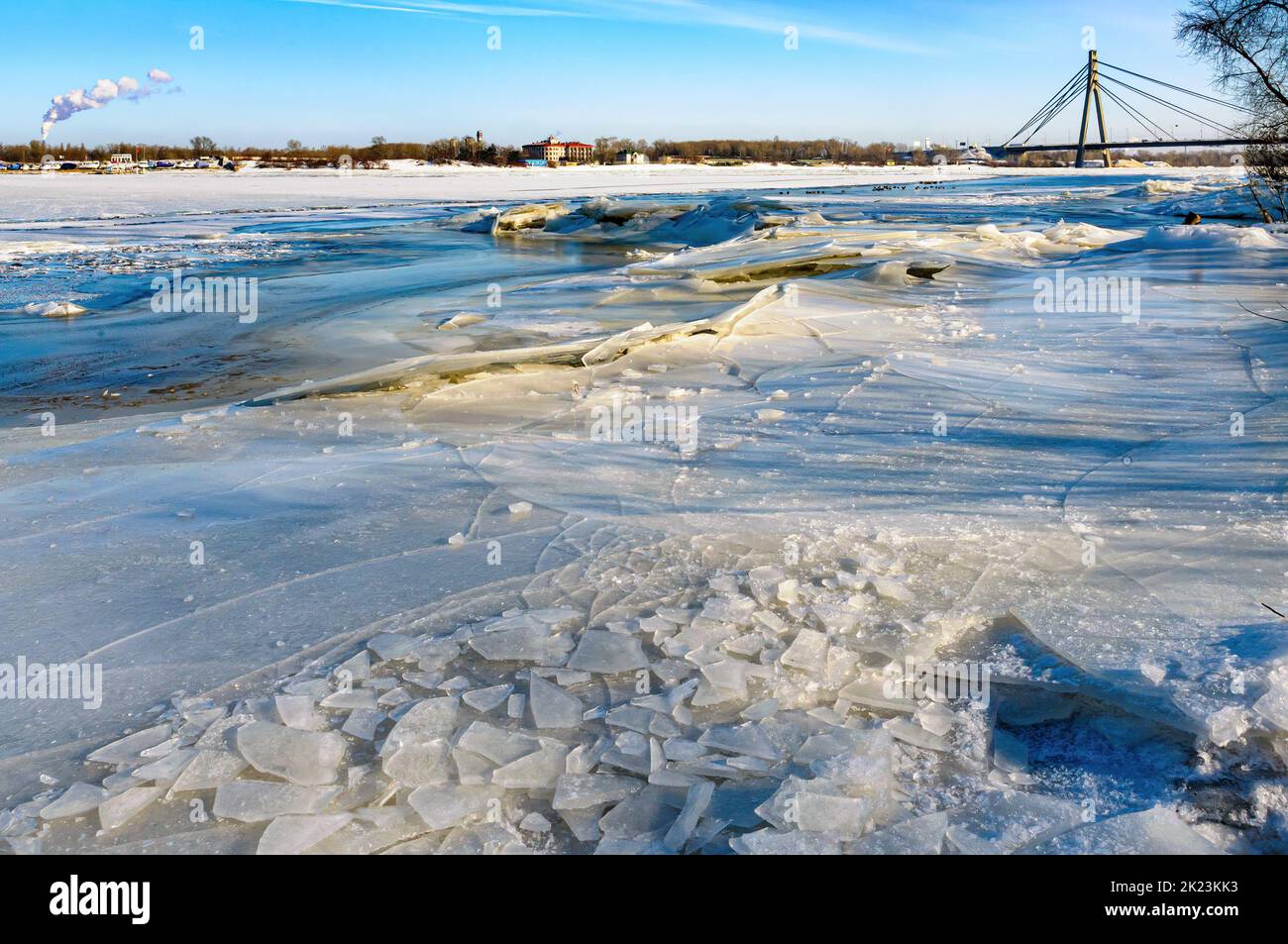 Fishermen on the frozen Dnieper in the Obolon district of Kiev, Ukraine, during a cold winter. In the background the Pivnichnyi (ex Moskovsky) bridge. Stock Photo