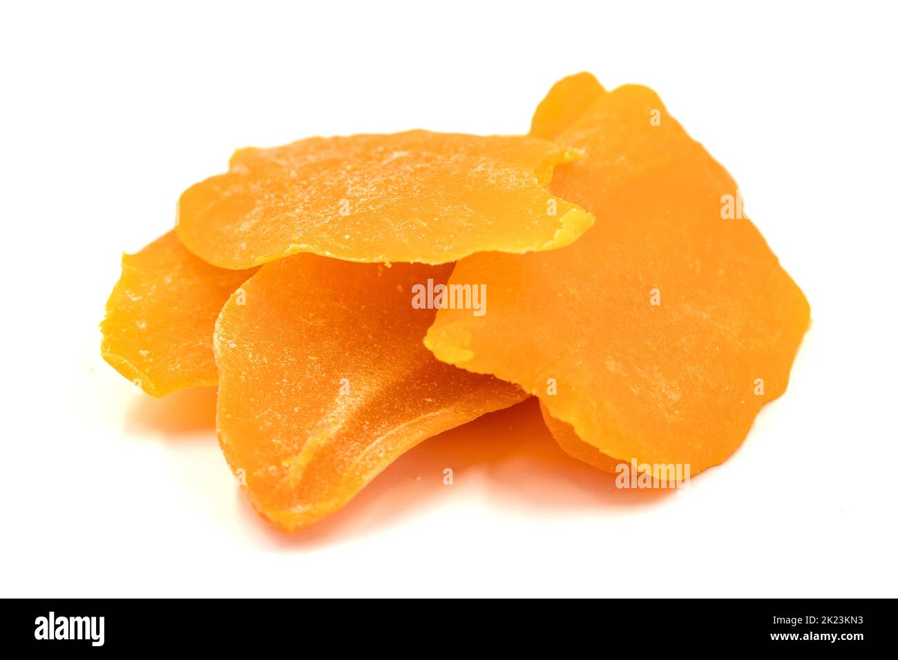 Dried mango slice isolated on white background. Dried fruit in sunlight
