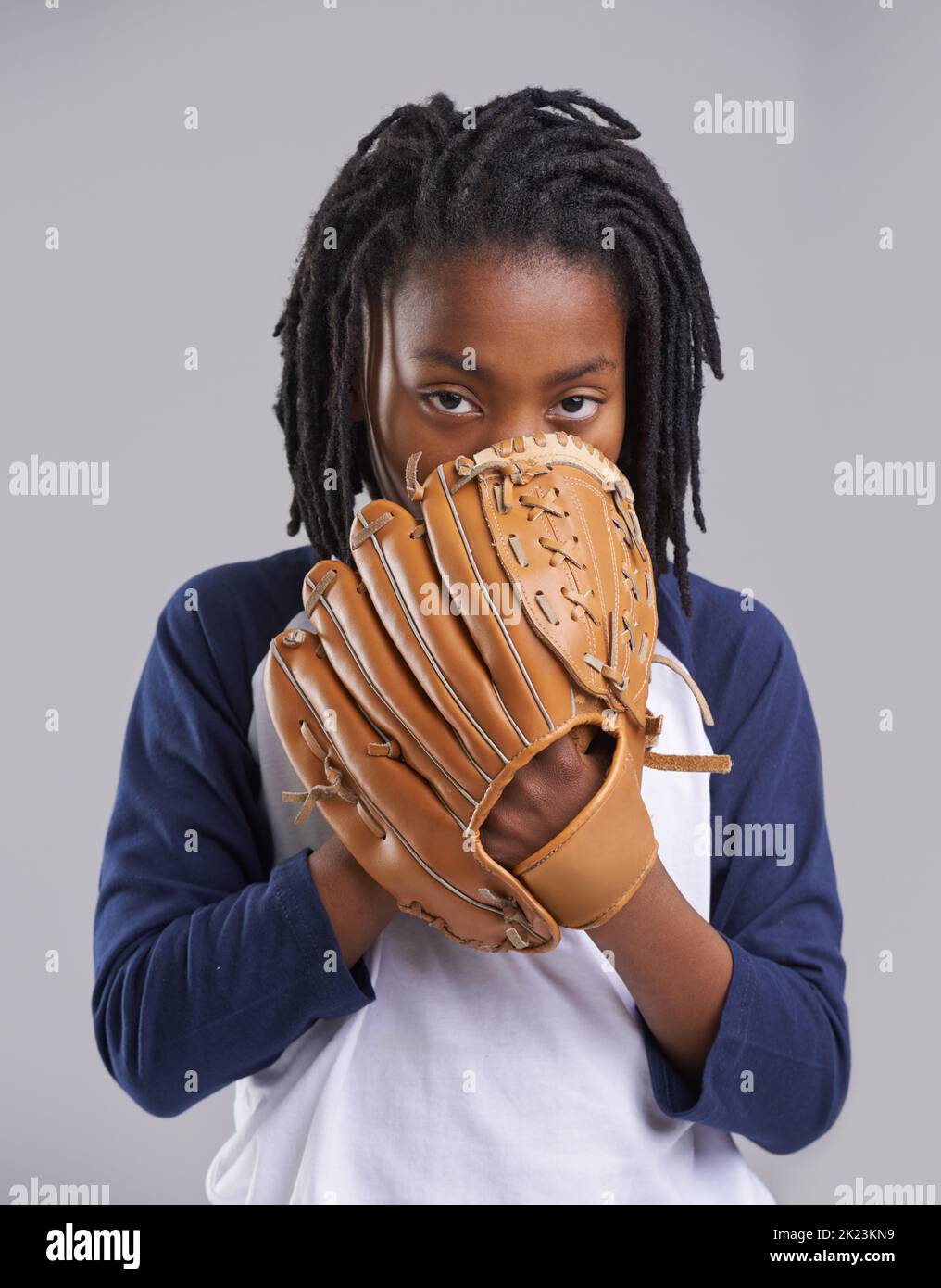 You wont know what hit you. Studio shot of a young boy with baseball gear. Stock Photo