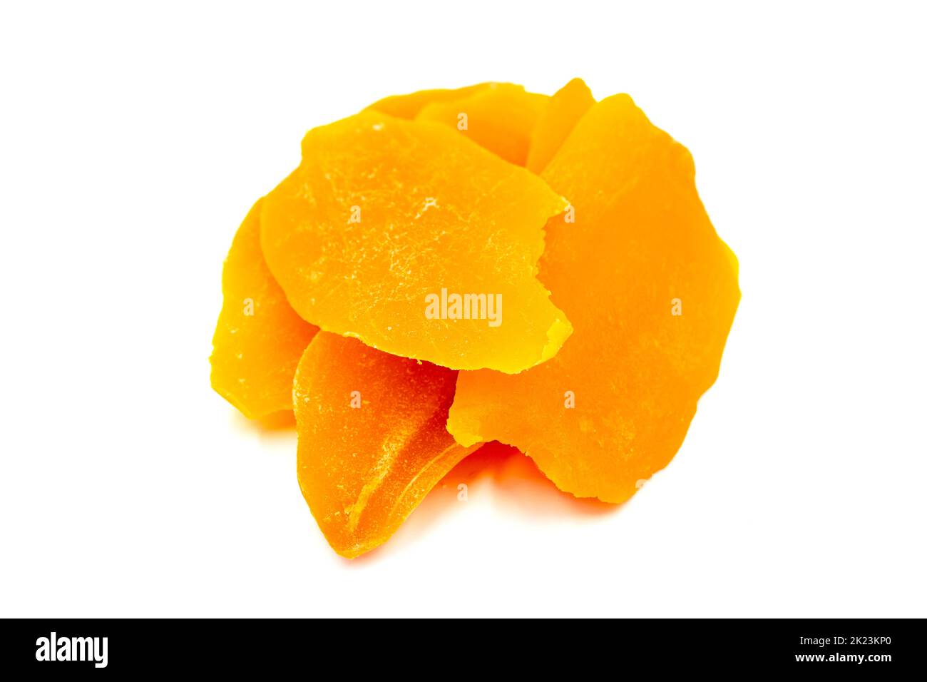 Dried mango slice isolated on white background. Dried fruit in sunlight. close up Stock Photo