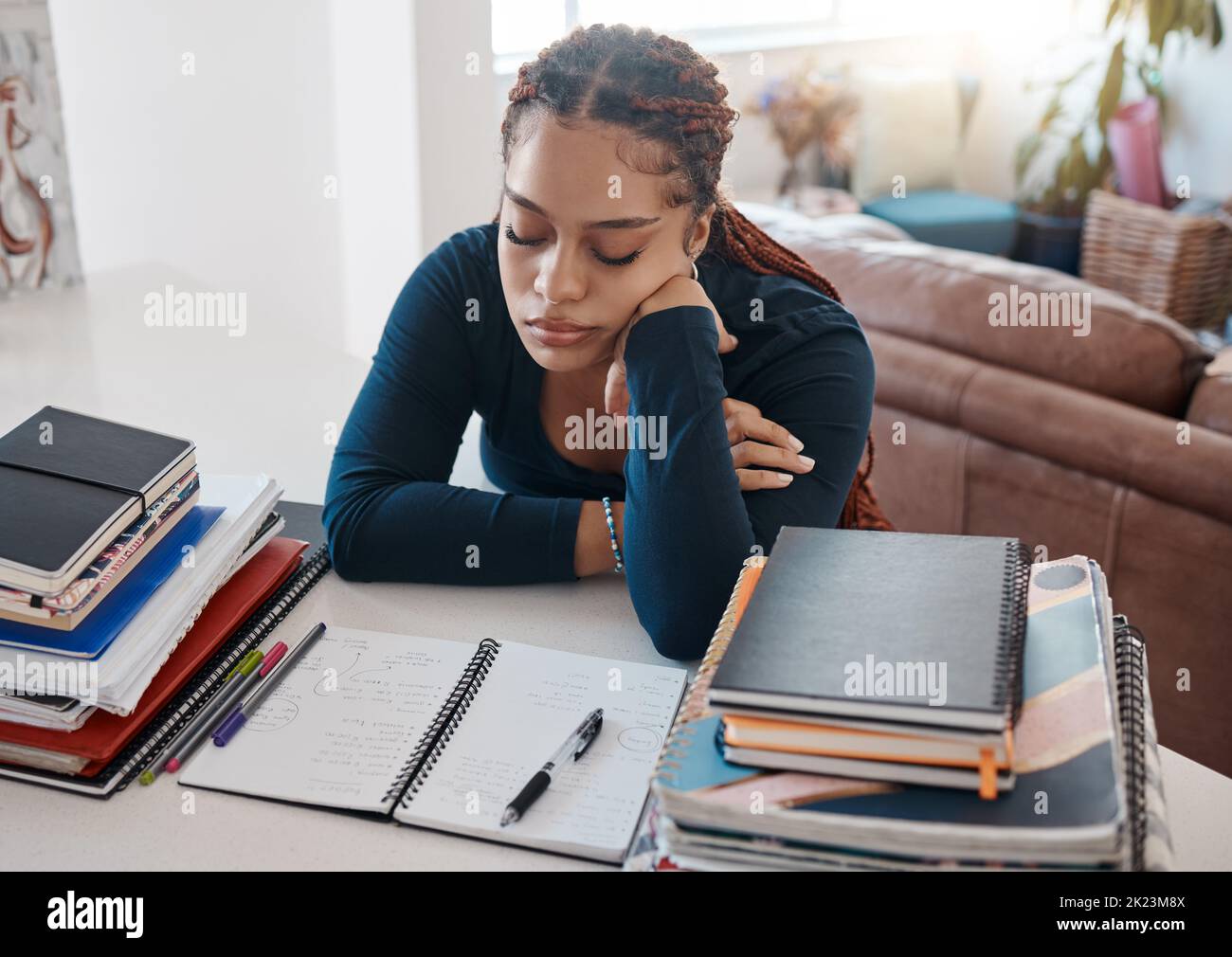 Sleep, books and black woman student writing homework in notebook or