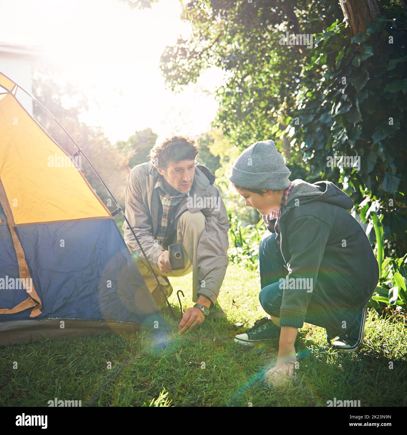 Roughing it in the wild with his lil dude. a father and his young son putting up their tent. Stock Photo