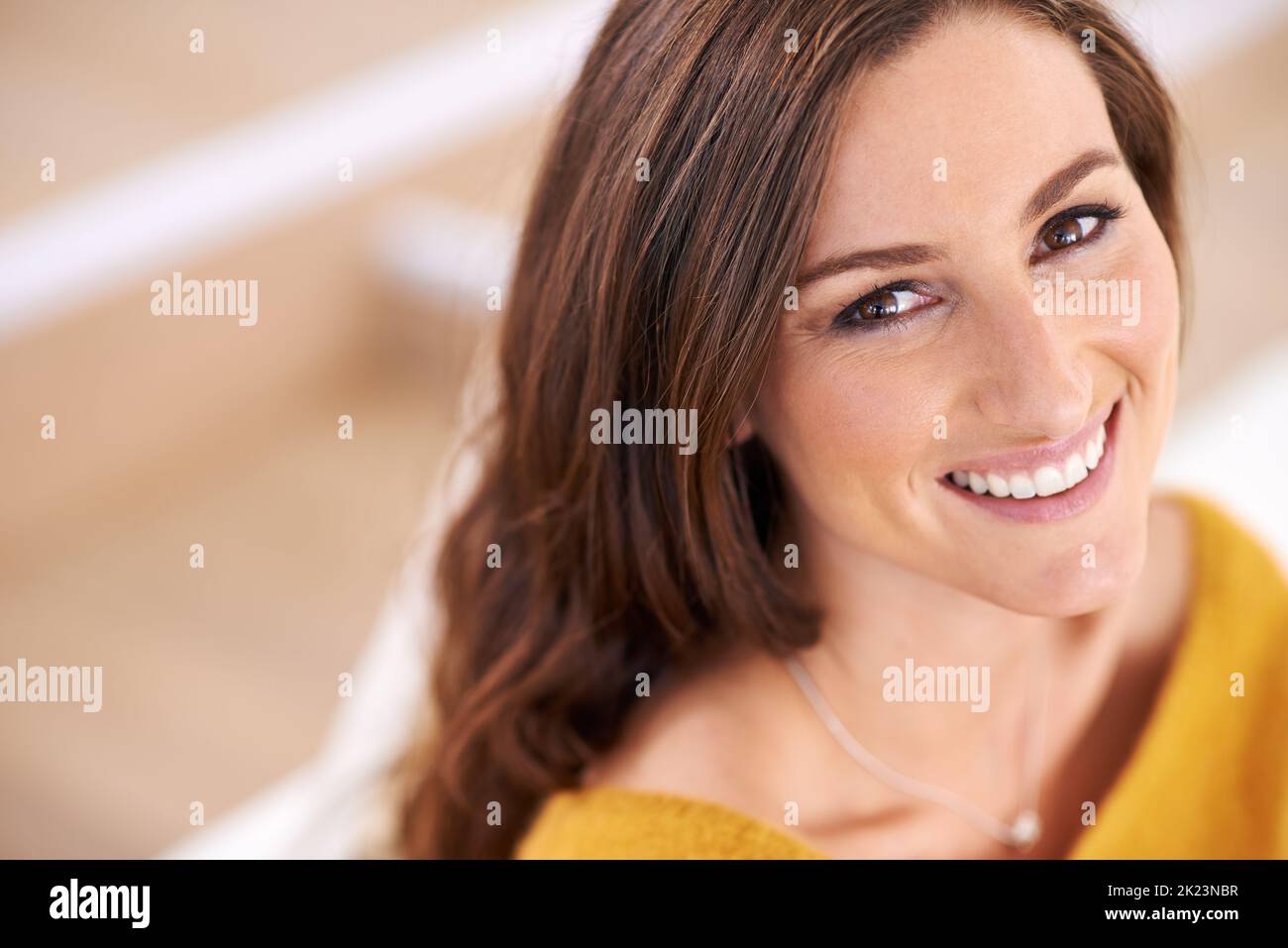 She has a smile like heaven. Closeup shot of a beautiful young woman sitting indoors. Stock Photo