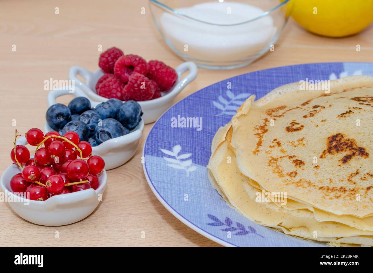 pile of pancakes served on a plate with berries Stock Photo